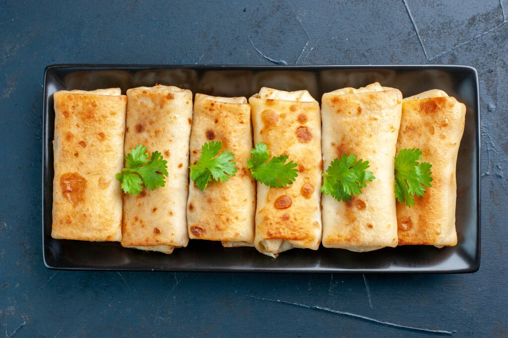 top-view-delicious-lavash-wraps-black-plate-dark-blue-background.jpg