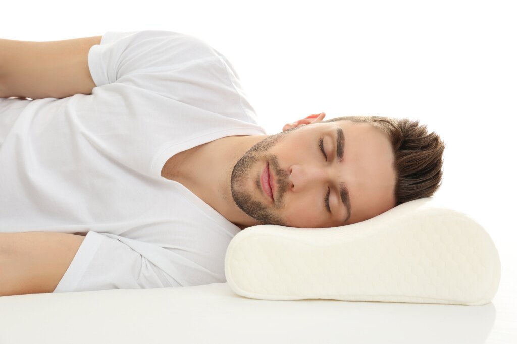 young-man-sleeping-bed-with-orthopedic-pillow-against-white-background-healthy-posture-concept.jpg