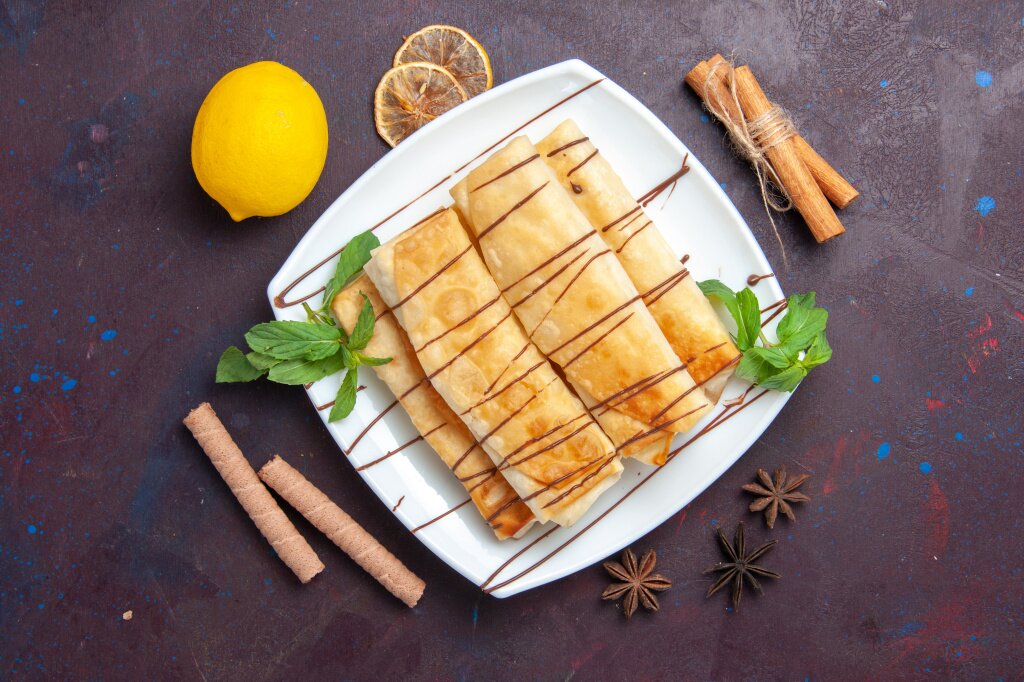 top-view-delicious-sweet-pastries-with-lemon-dark-space.jpg