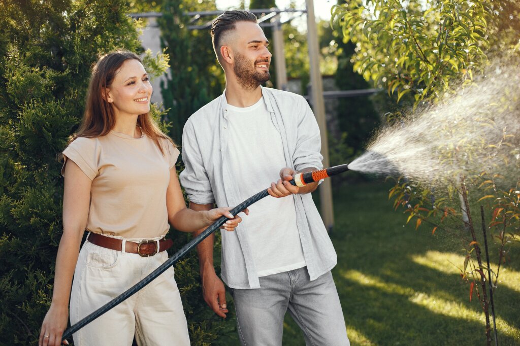 couple-watering-his-plants-his-garden-man-blue-shirt-family-works-backyard.jpg