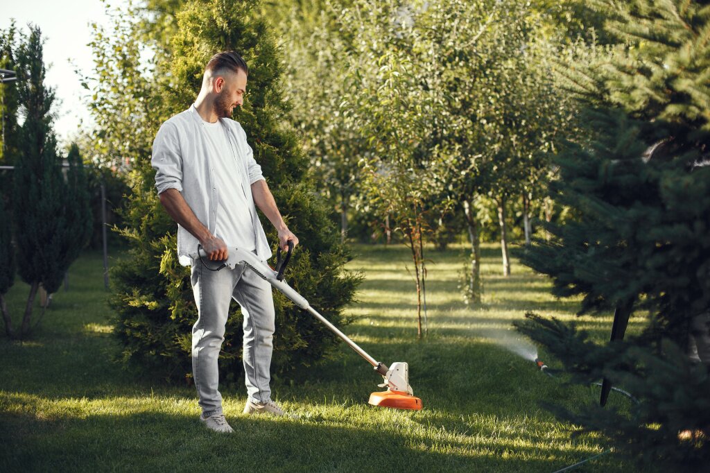 man-cutting-grass-with-lawn-mover-back-yard-male-shirt.jpg