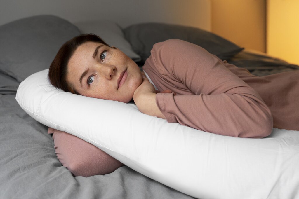 medium-shot-pregnant-woman-laying-home.jpg