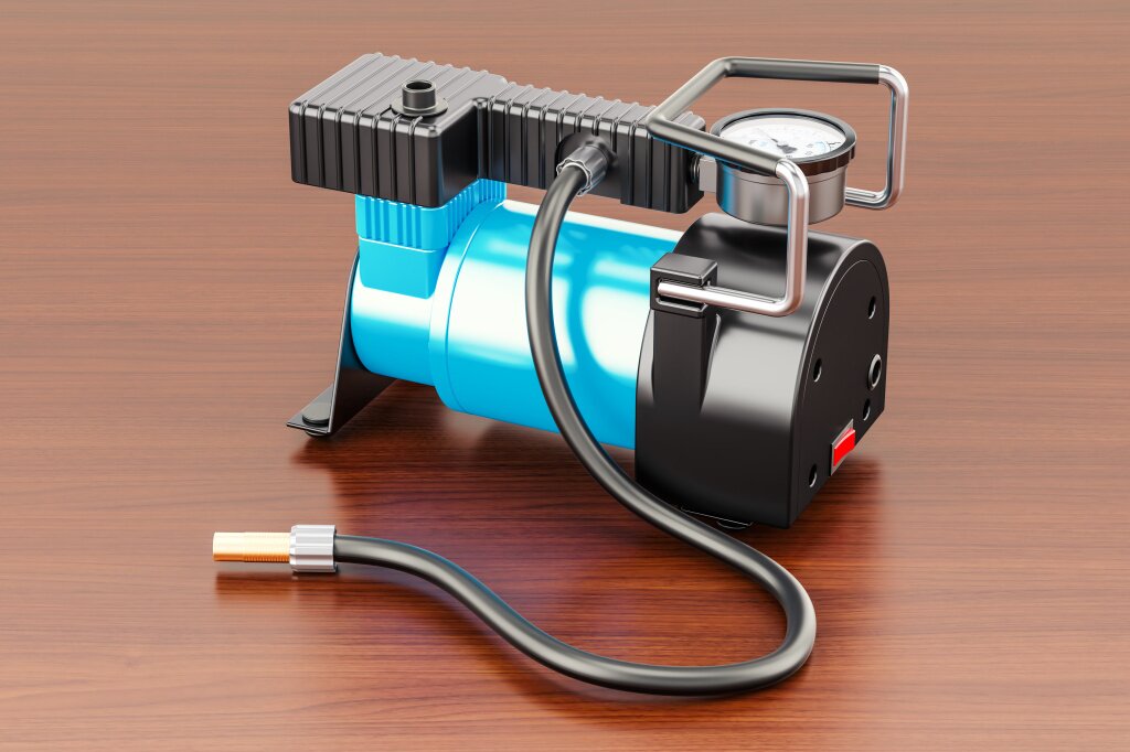 avtomobil-nyi-portativnyi-elektriceskii-vozdusnyi-kompressor-na-derevannom-stole-3d-rendering.jpg