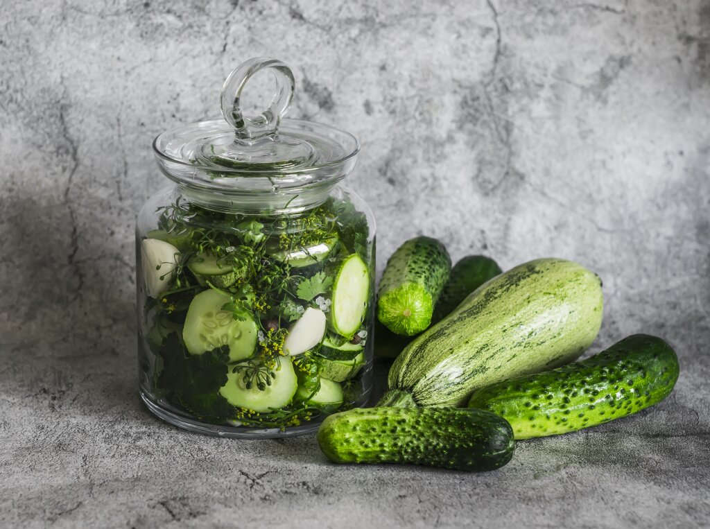 pickled-zucchini-cucumbers-with-coriander-garlic-dill-glass-jar-gray-background.jpg