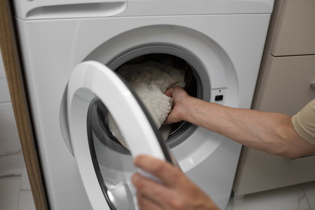high-angle-adult-loading-washing-machine.jpg