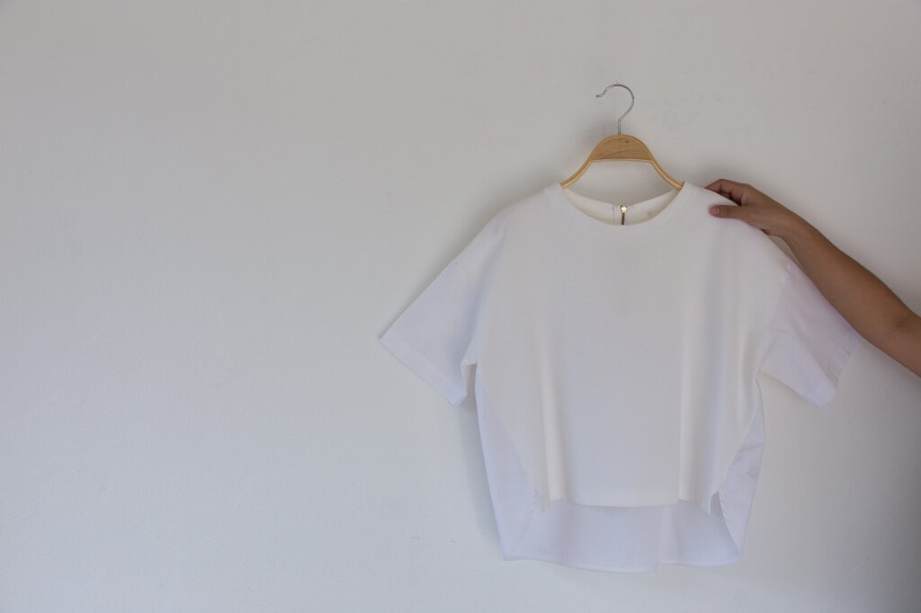cropped-hand-holding-cloth-against-white-background.jpg