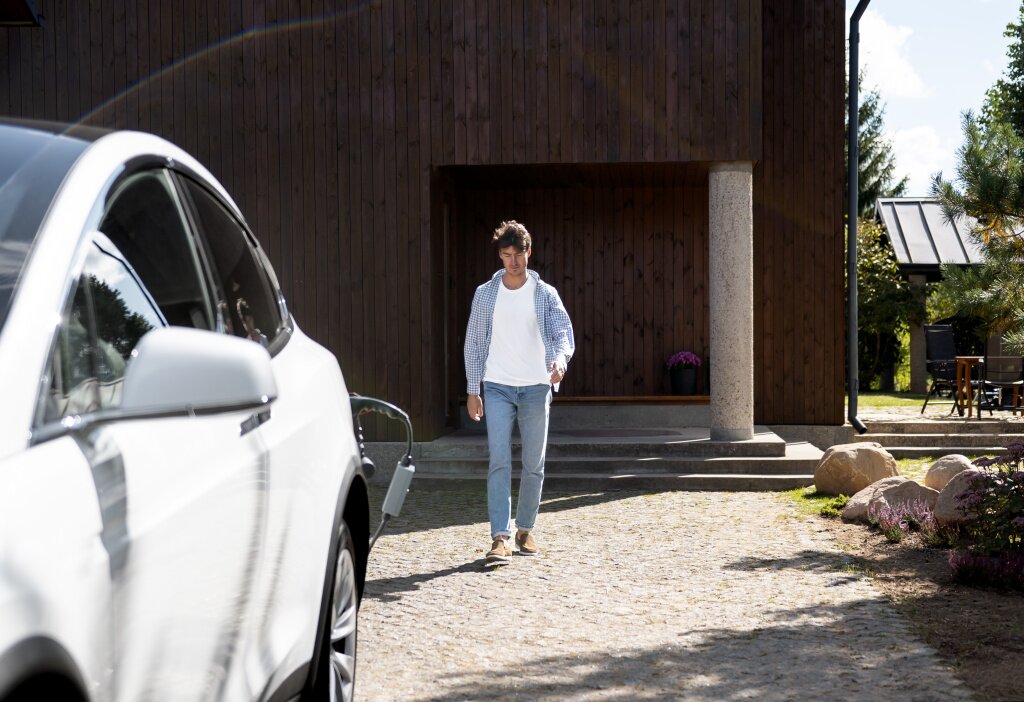 person-taking-care-electric-car.jpg